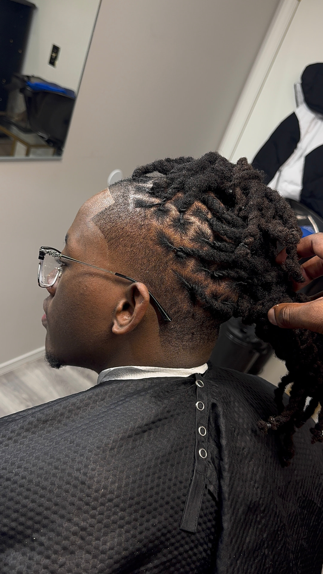 Completed loc set with a clean taper, locs lifted and presented by the loctician