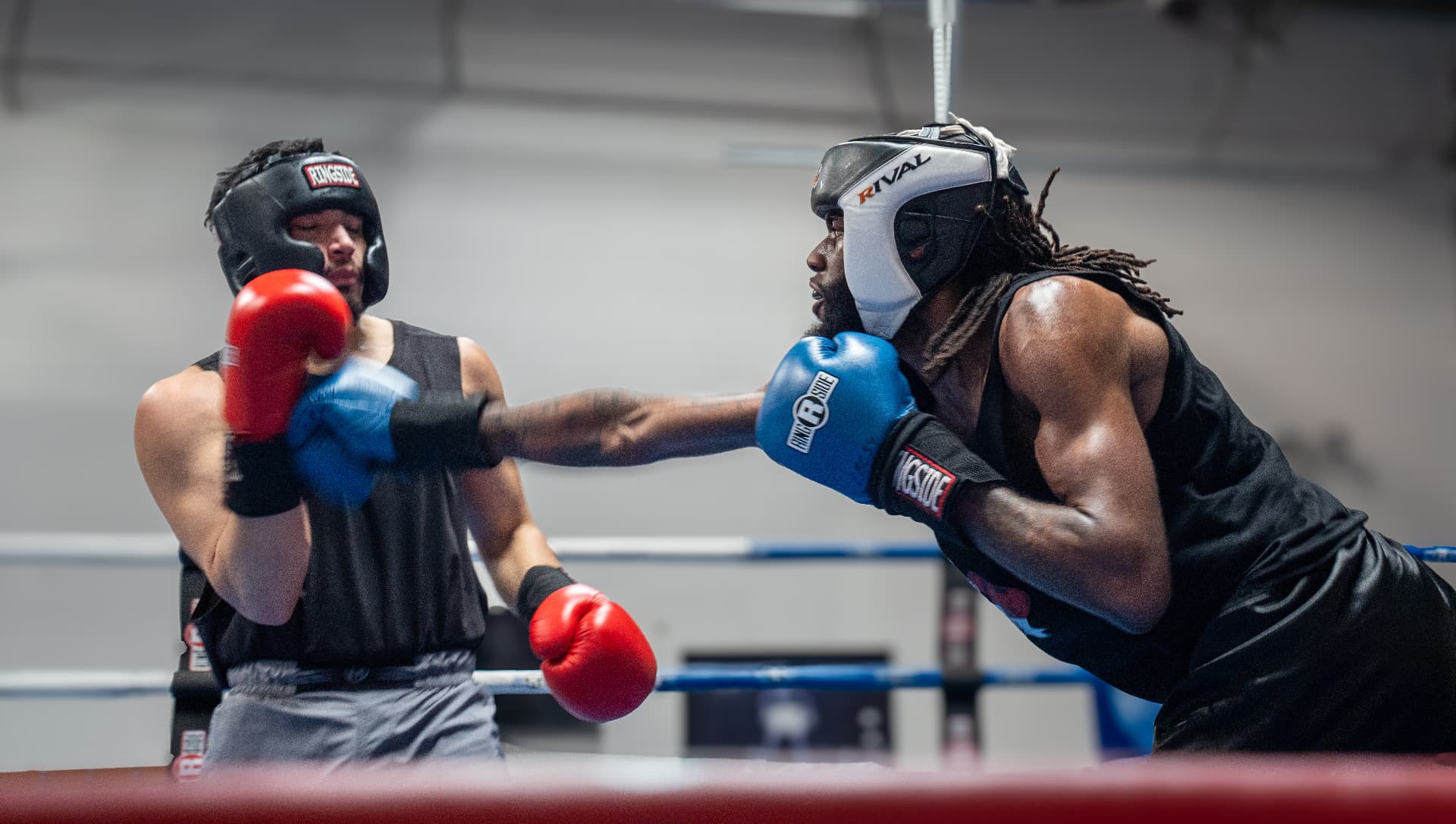 Jayy Klipsz landing a jab with blue gloves during a sparring round in the ring