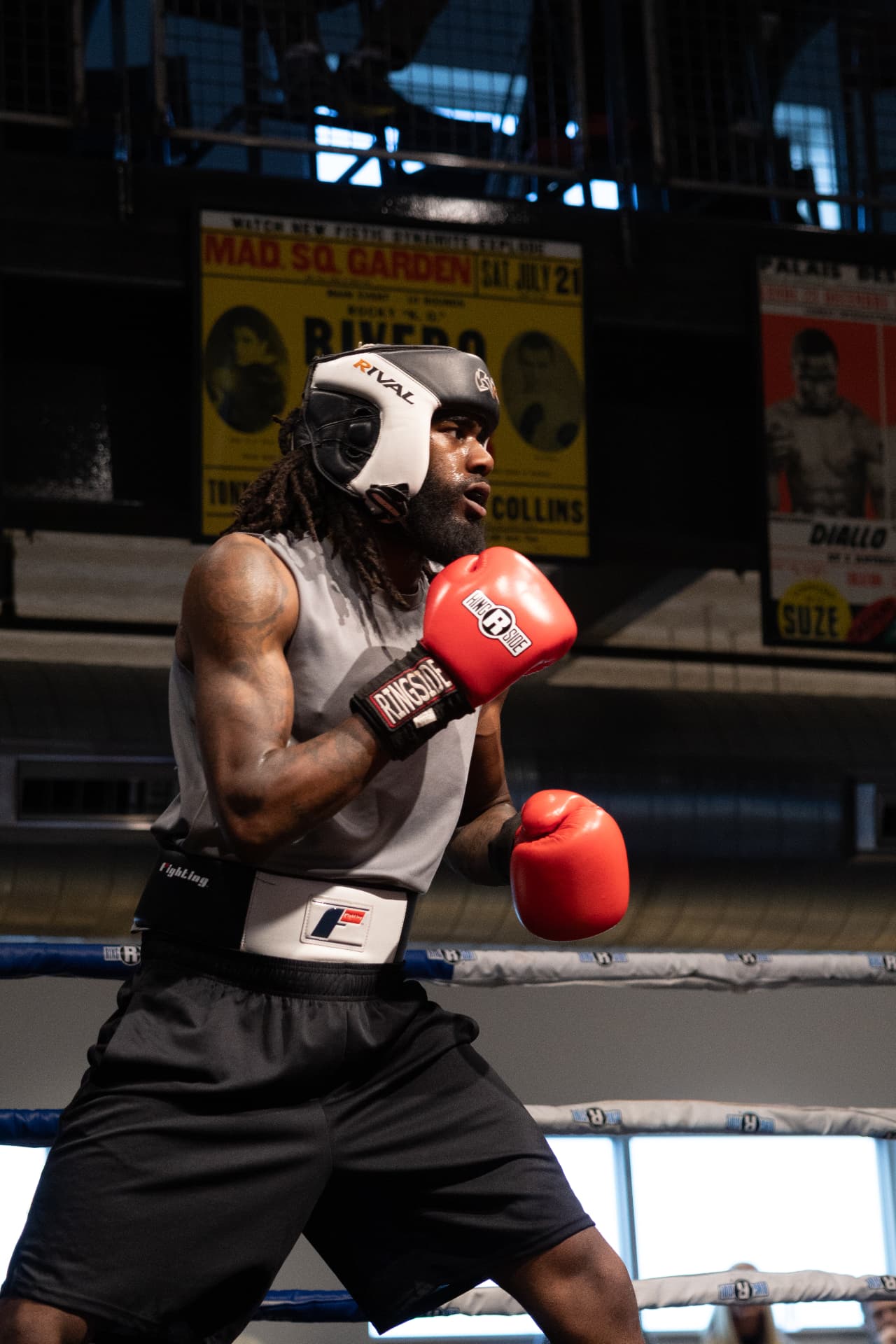 Jayy Klipsz in boxing stance with red gloves and headgear inside the ring