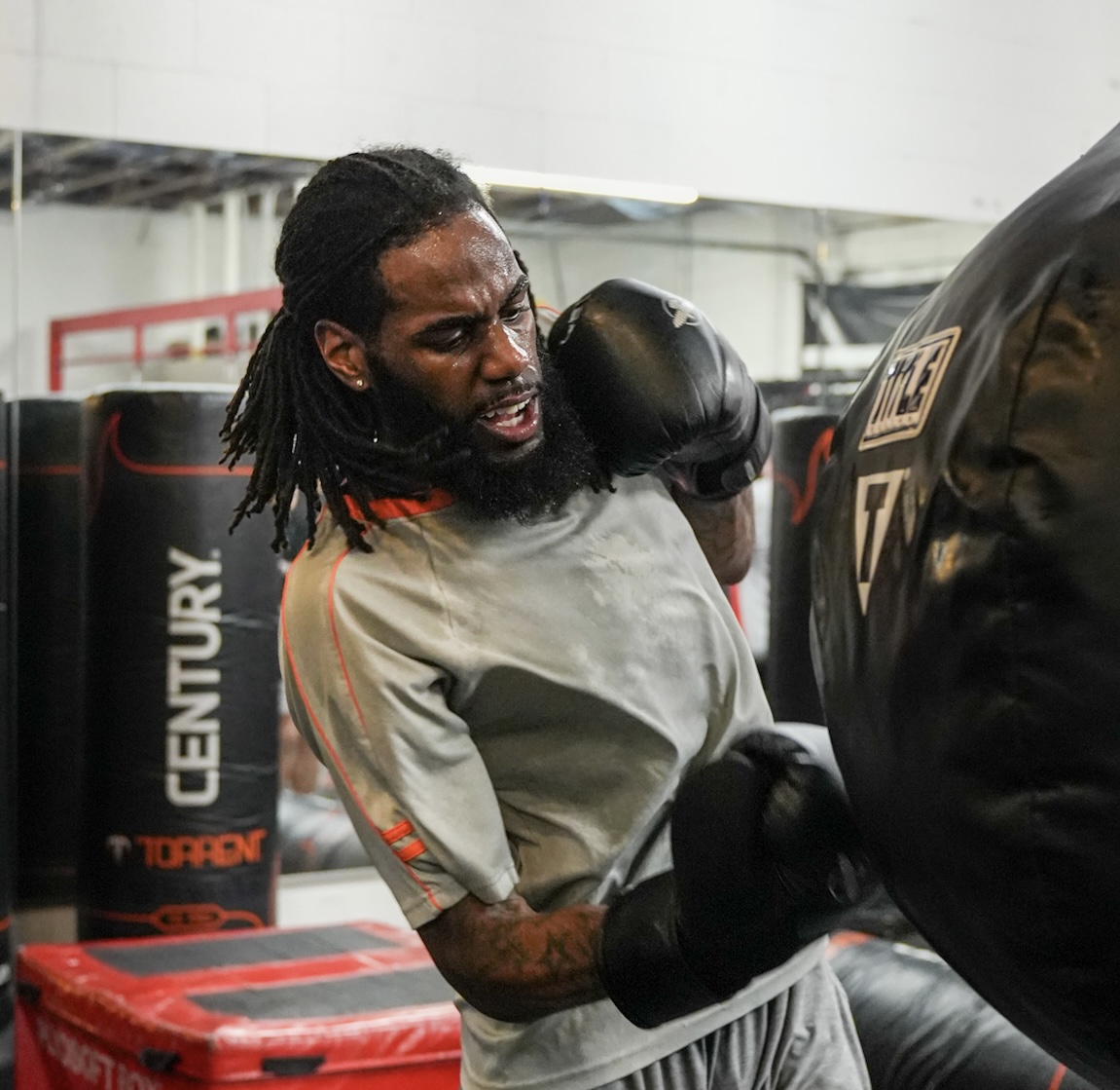 Jayy Klipsz driving a hook into a heavy bag during conditioning work