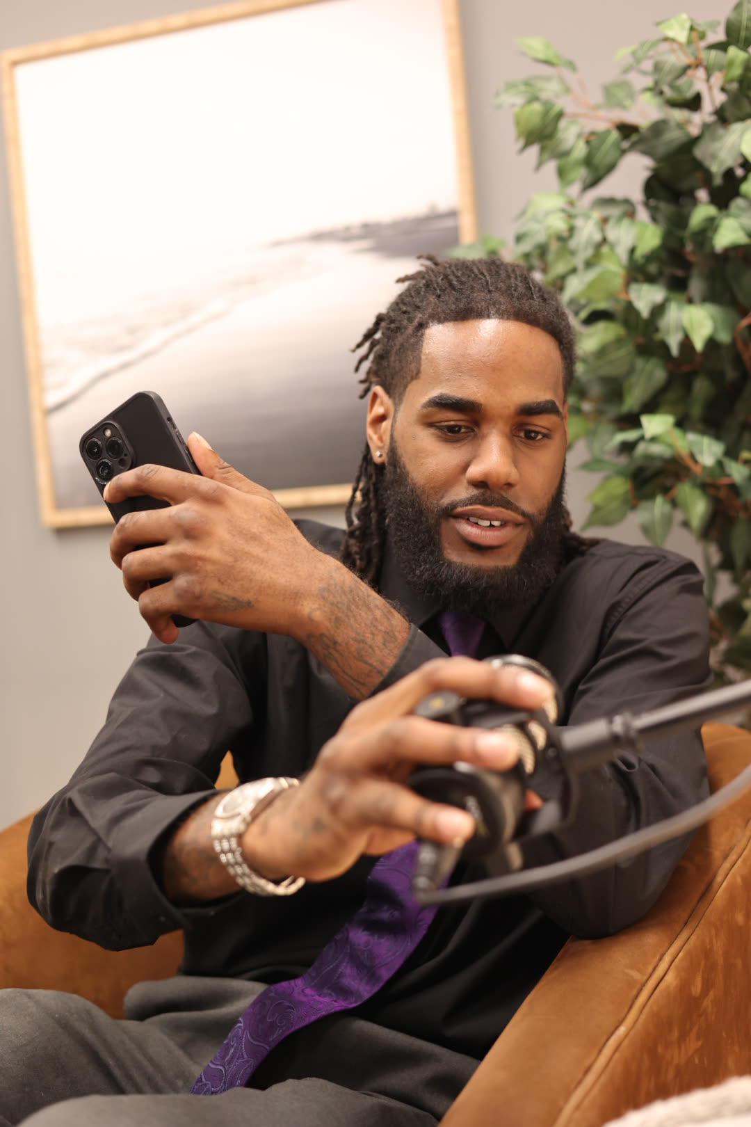 Jayy Klipsz speaking while setting up a microphone during a recorded session